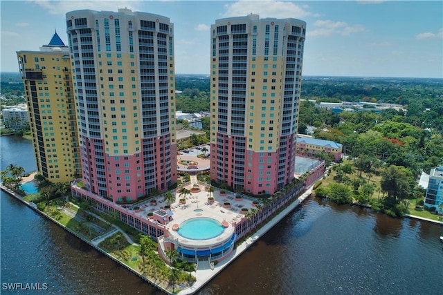 birds eye view of property featuring a water view and a city view