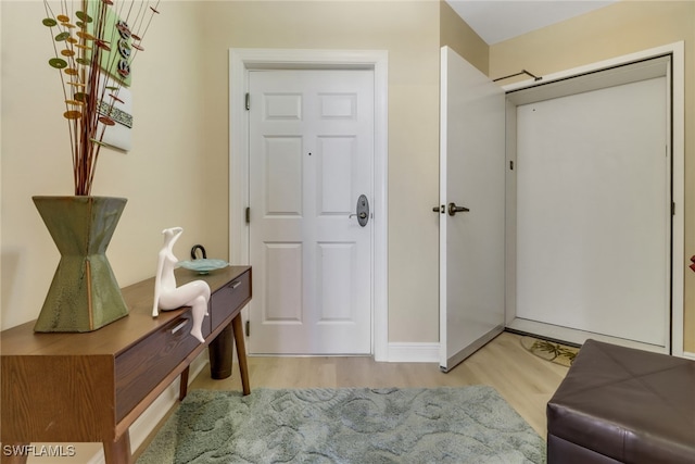 entryway with wood finished floors