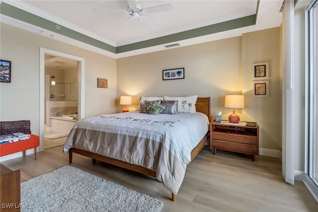 bedroom with ornamental molding, visible vents, light wood-style floors, and baseboards