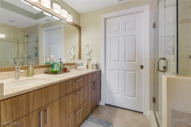 full bathroom with double vanity, a sink, and a shower stall