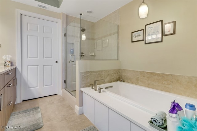 bathroom featuring visible vents, vanity, a shower stall, and a bath