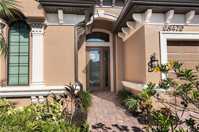 view of exterior entry featuring a garage