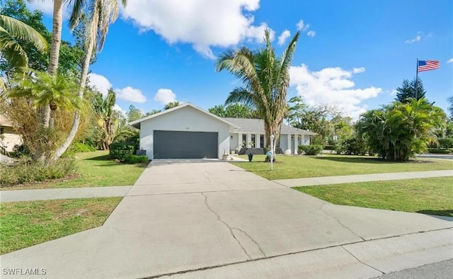 ranch-style home with a garage and a front lawn