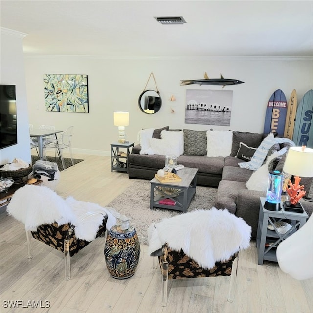 living room with hardwood / wood-style floors and crown molding