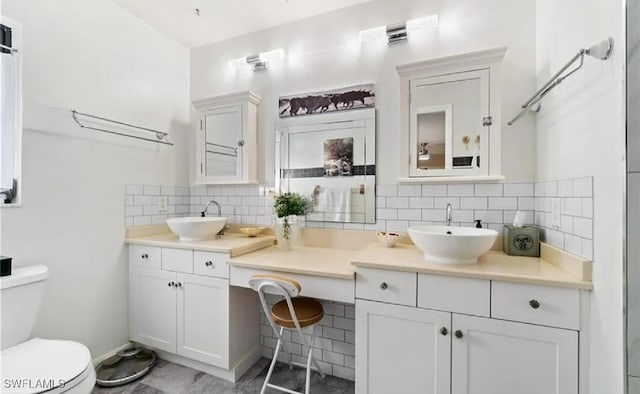 bathroom featuring decorative backsplash, vanity, and toilet