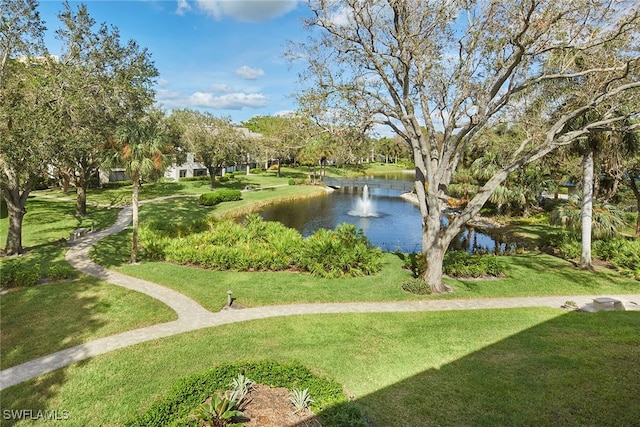 view of community with a lawn and a water view