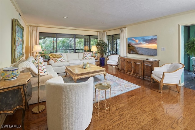 living room with wood-type flooring, a textured ceiling, and crown molding