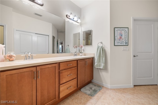 bathroom with tile patterned floors and vanity