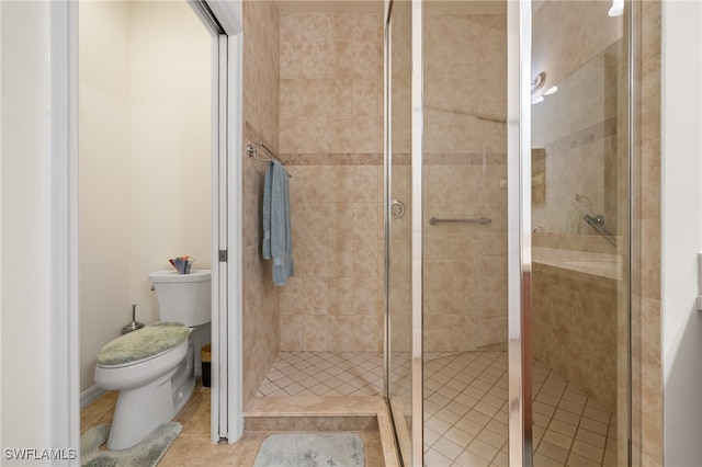 bathroom featuring tile patterned floors, toilet, and walk in shower