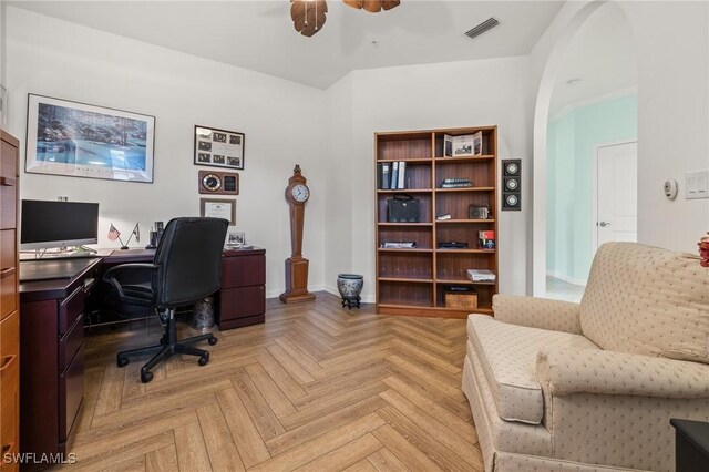 home office with ceiling fan and light parquet floors