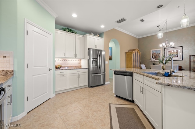 kitchen with white cabinetry, sink, stainless steel appliances, a chandelier, and pendant lighting