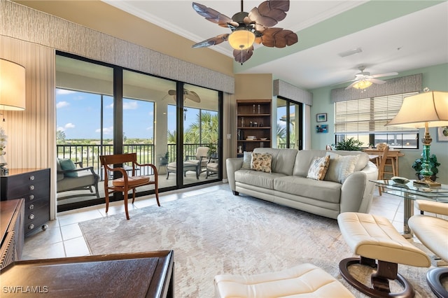 living room featuring ceiling fan, ornamental molding, and light tile patterned flooring