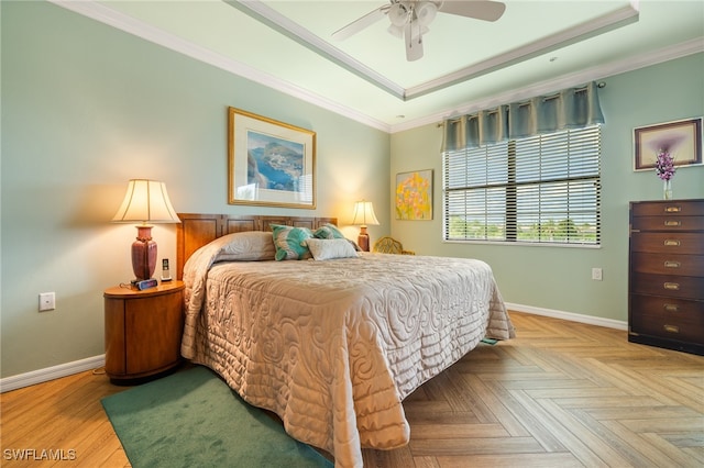 bedroom featuring light parquet flooring, a raised ceiling, ceiling fan, and crown molding