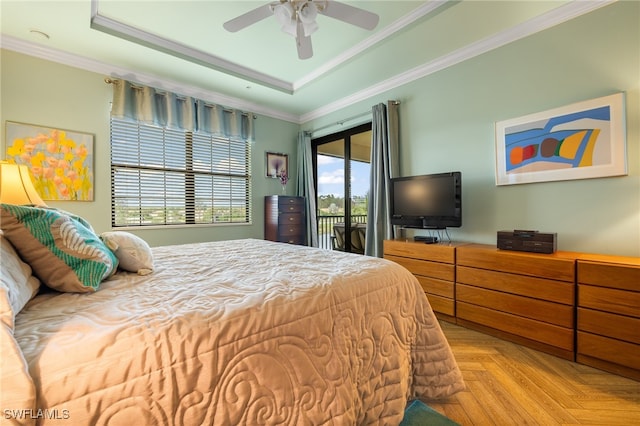 bedroom with access to exterior, light parquet floors, a raised ceiling, and crown molding