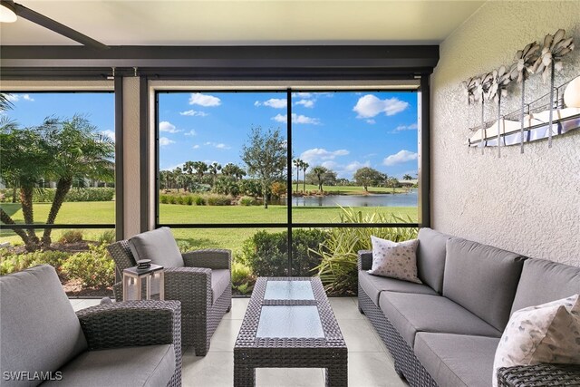 sunroom / solarium featuring a water view