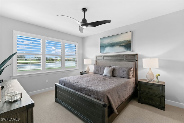 bedroom featuring light carpet and ceiling fan