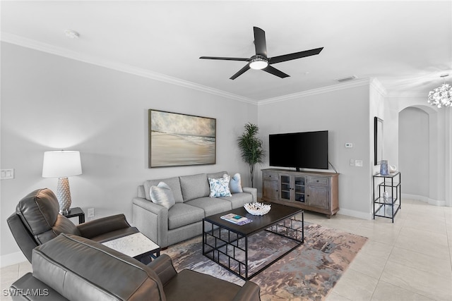 tiled living room with ceiling fan with notable chandelier and crown molding