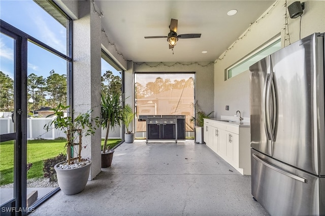 view of patio featuring ceiling fan and sink