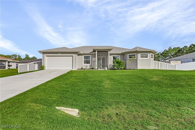 view of front of home with a garage and a front lawn