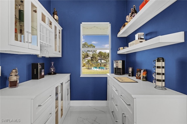 bar featuring white cabinets