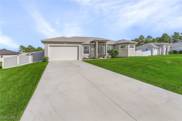 view of front of property featuring a front yard and a garage