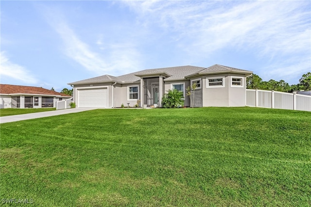 prairie-style home with a front lawn and a garage