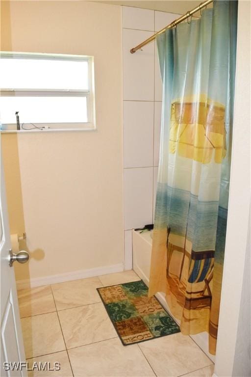 bathroom featuring tile patterned flooring and shower / bath combination with curtain