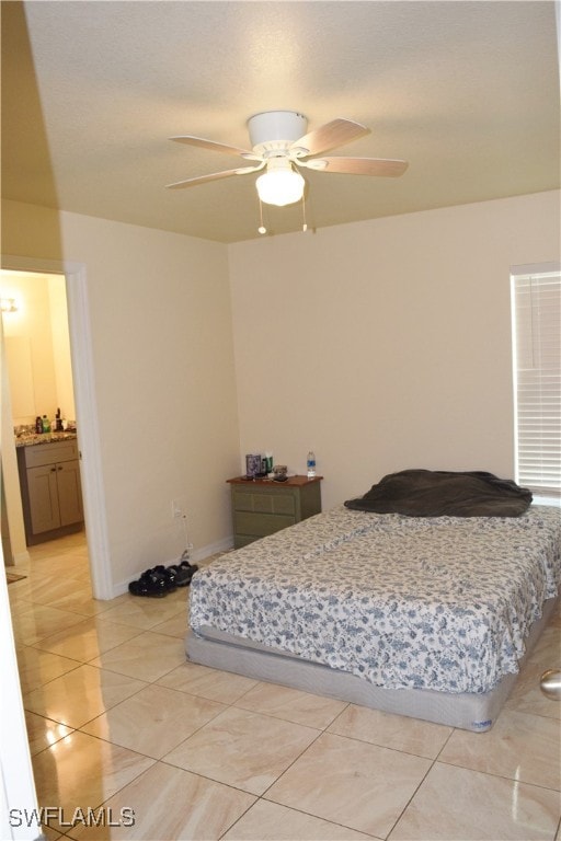 bedroom with ceiling fan and light tile patterned floors