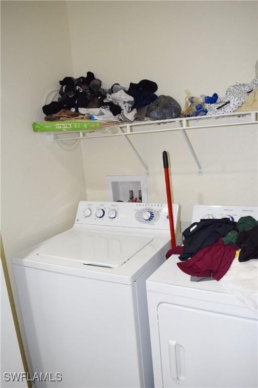 clothes washing area with washer and dryer