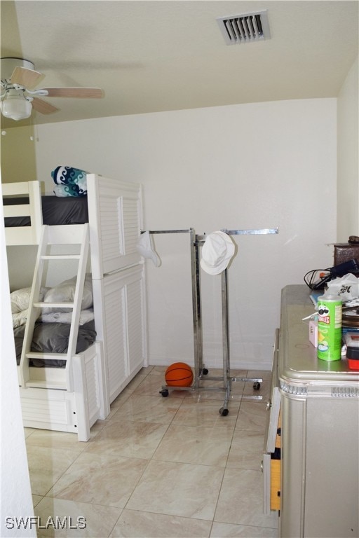 washroom featuring ceiling fan and light tile patterned floors