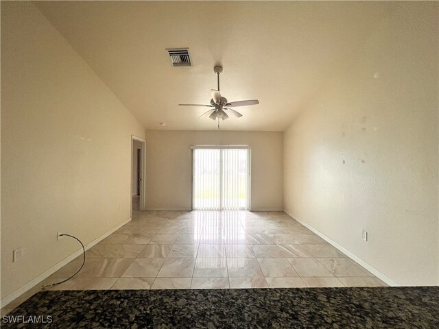 empty room with ceiling fan and lofted ceiling