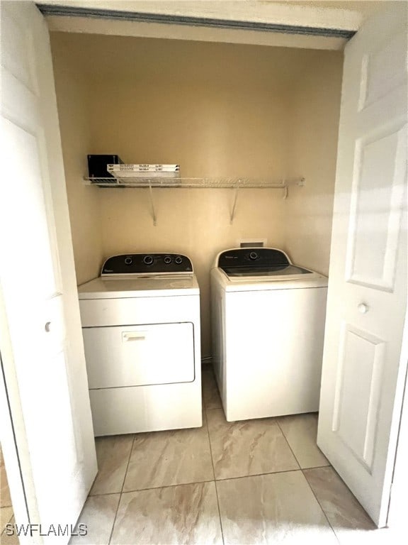 clothes washing area featuring independent washer and dryer