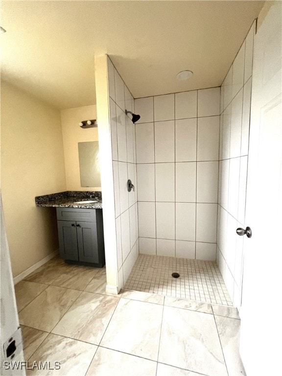 bathroom featuring vanity and a tile shower