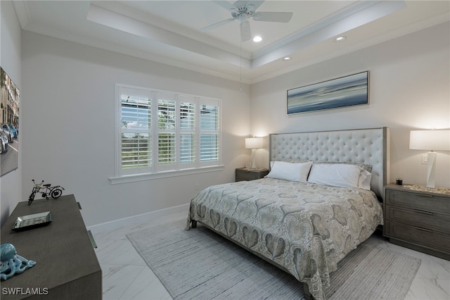 bedroom with a tray ceiling, ceiling fan, and ornamental molding