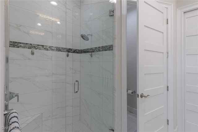 bathroom featuring a shower with door