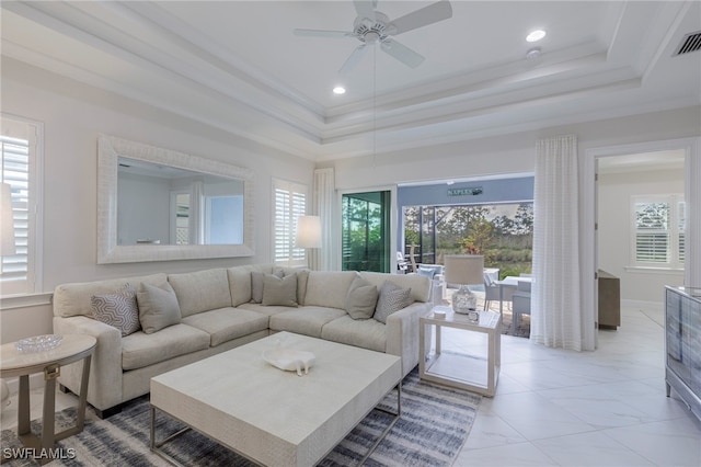 living room with plenty of natural light, ornamental molding, and ceiling fan