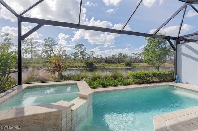 view of swimming pool featuring an in ground hot tub, a water view, and a lanai