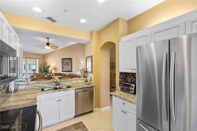 kitchen with white cabinetry, sink, and stainless steel appliances