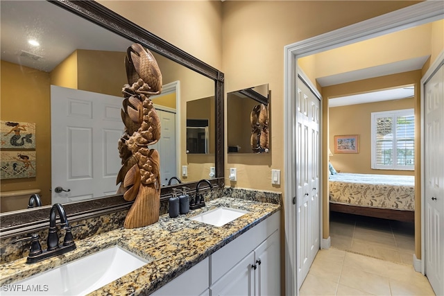 bathroom featuring tile patterned flooring and vanity