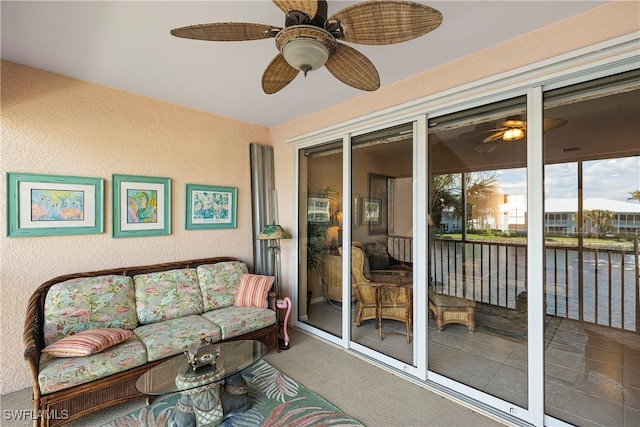 sunroom / solarium featuring ceiling fan