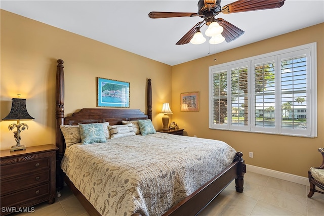 bedroom with ceiling fan and light tile patterned floors