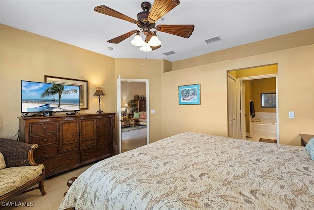 bedroom featuring ensuite bathroom, ceiling fan, and light tile patterned flooring