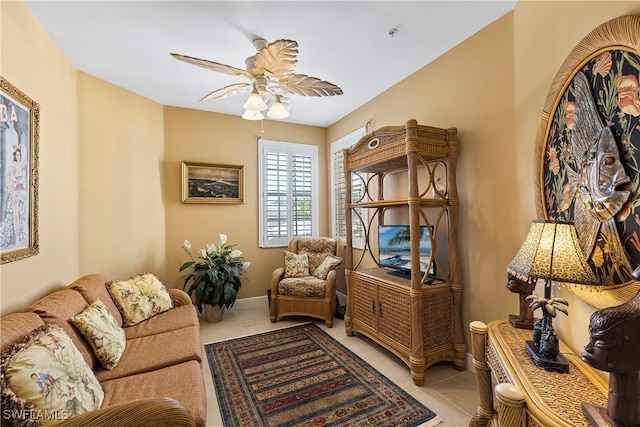 sitting room featuring light tile patterned floors and ceiling fan