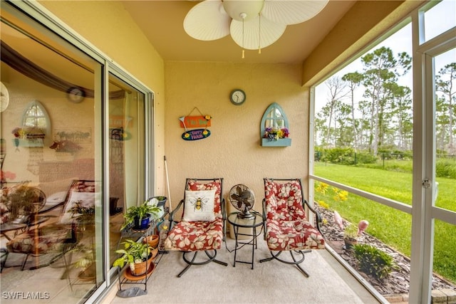 sunroom with ceiling fan and plenty of natural light