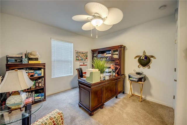 carpeted office space with ceiling fan