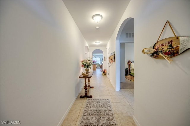 hall featuring light tile patterned flooring