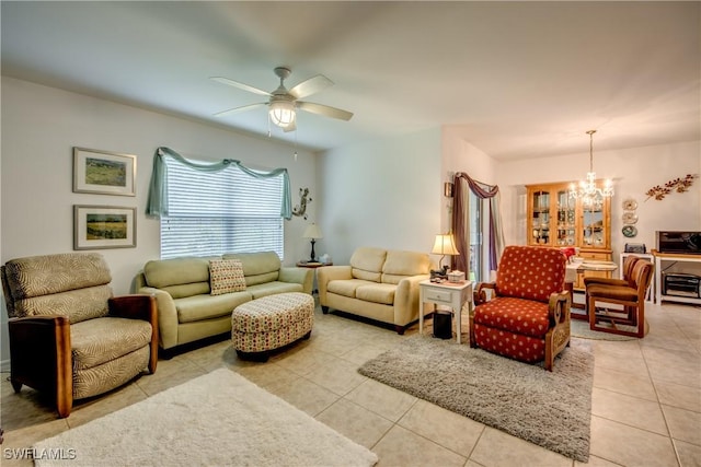 tiled living room featuring ceiling fan with notable chandelier