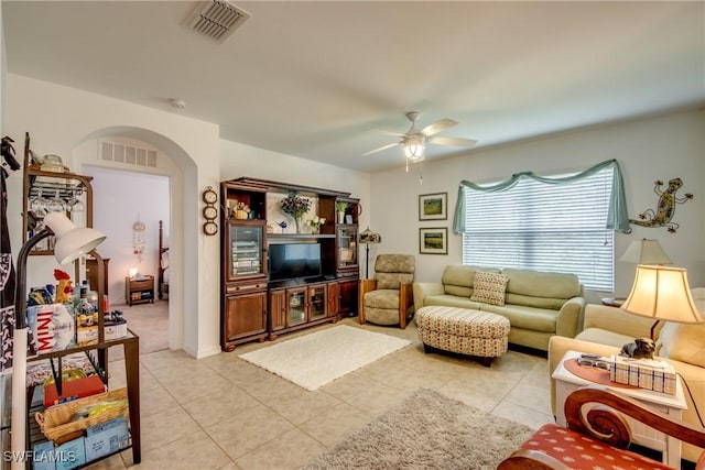 tiled living room with ceiling fan