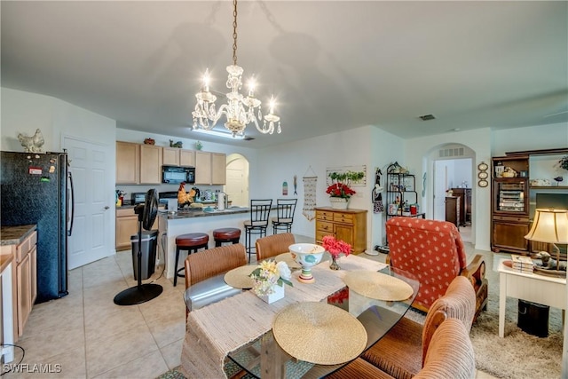 tiled dining area featuring a notable chandelier