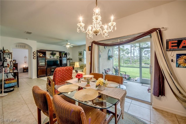 tiled dining space featuring ceiling fan with notable chandelier